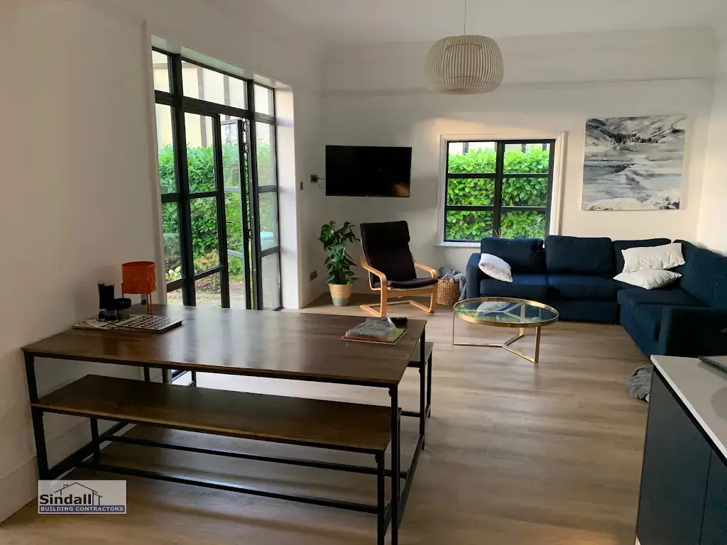 Refurbished open plan living and dining space with steel-look glazed doors to the garden, engineered oak flooring and a new ceiling pendant